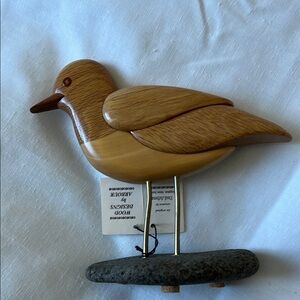 Light Brown Wooden Bird Toy with Detailed Carving and Metal Legs